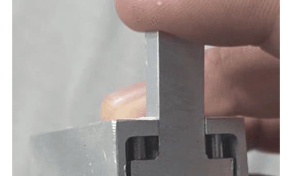 Aluminum device with a hinge and a cutting button, held in one hand